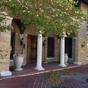Entryway featuring three arches supported by stone columns.  Urns and Roman Classical statuary are common additions.