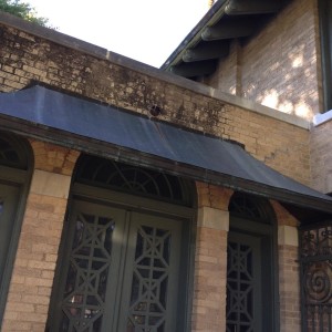 A close up of the exterior of the sunroom windows.  The ornamentation is wood, not metal.  