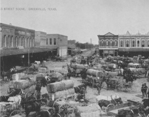The Public Square in Greenville, Texas, ca. 1882.  Farmers brought their cotton to town to sell each fall.  If a street buyer, dressed in a suit, had his foot on the spokes of a wagon wheel, everyone knew the load was mortgaged to a furnishing merchant as crop lien.  