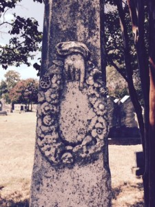 An unusual obelisk found at East Mount Cemetery in Greenville, Texas.  Usually the hand and finger are pointed upward toward Heaven, but this indicates a woman holding a wreath full of mourning flowers.  