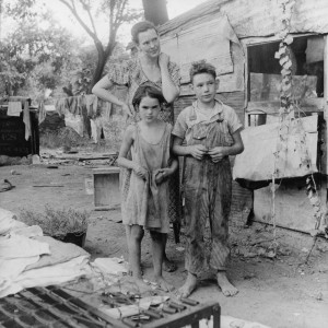 How about, A mother and her two children eking out an existence.  More than 14 million Americans were without work, had lost their homes, and seldom knew what the next meal would be at the height of the Great Depression.  The New Deal attempted to put people to work in order for them to be able to provide food and shelter from their own earnings.  It didn’t always work that way.