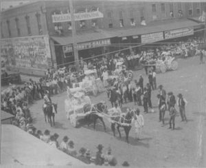Turning the corner at Washington and Johnson Streets, the beautiful Mississippi Store float with yellow and white paper flowers intrigued on-lookers. 
