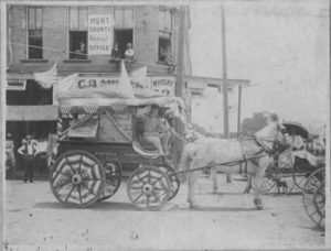 The American Express workers decorated on of their freight wagons in very patriotic colors. Note the young men sitting in the windows.