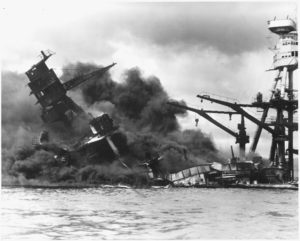 USS Arizona burning at Pearl Harbor, December 7, 1941 with 1, 774 crew members aboard who lost their lives.  All twenty-one members of the Arizona’ band, known as U. S. Navy Band Unit (NBU) 22 died.  (Photo from Wikimedia Commons)